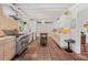 Spacious kitchen with stainless steel appliances, custom cabinets, kitchen island and red tiled floor at 122 Miramar Ne Blvd, St Petersburg, FL 33704