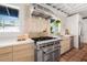 Bright kitchen featuring stainless steel stove, custom cabinets, counter space, and tiled floor at 122 Miramar Ne Blvd, St Petersburg, FL 33704