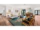 Comfortable living room with terra cotta tile flooring, a modern sofa, and a unique area rug at 122 Miramar Ne Blvd, St Petersburg, FL 33704