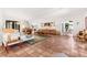 Open living room featuring a white sofa, piano, accent rug, and terra cotta tile flooring at 122 Miramar Ne Blvd, St Petersburg, FL 33704