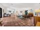 Bright living room with terra cotta tile, white sofa, piano, area rug, and stylish decor at 122 Miramar Ne Blvd, St Petersburg, FL 33704