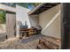 Cozy outdoor kitchen area complete with a grill, storage, and a rustic wooden bench at 122 Miramar Ne Blvd, St Petersburg, FL 33704