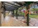 Inviting outdoor patio with tile flooring, a covered structure, and lush tropical plants at 122 Miramar Ne Blvd, St Petersburg, FL 33704