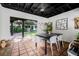 Covered outdoor patio with dining table, chairs and view to the backyard at 122 Miramar Ne Blvd, St Petersburg, FL 33704