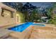 Backyard pool with patio, lounge chairs, spa and lush tropical landscaping at 122 Miramar Ne Blvd, St Petersburg, FL 33704