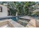 Backyard pool with patio, privacy landscaping, lounge seating, and clear water at 122 Miramar Ne Blvd, St Petersburg, FL 33704