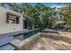 Modern pool and spa with stone tile deck and privacy landscaping at 122 Miramar Ne Blvd, St Petersburg, FL 33704