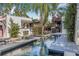 A serene pool area showcases the tranquil outdoor space, complemented by a well-maintained deck and lush greenery at 122 Miramar Ne Blvd, St Petersburg, FL 33704