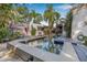 Backyard pool and patio featuring ample lounge seating and garden views at 122 Miramar Ne Blvd, St Petersburg, FL 33704