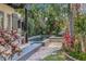 Backyard pool and patio area featuring stone tile, tropical landscape, and lush garden at 122 Miramar Ne Blvd, St Petersburg, FL 33704