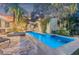 Luxury outdoor pool area with stone patio and lush landscaping at 122 Miramar Ne Blvd, St Petersburg, FL 33704