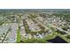 Expansive aerial view of a residential community featuring lush landscaping, tranquil ponds, and well-maintained homes at 12716 Evington Point Dr, Riverview, FL 33579
