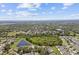 Aerial view of the residential area, displaying the layout of homes, tree coverage, and serene ponds at 12716 Evington Point Dr, Riverview, FL 33579