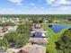 Aerial neighborhood shot with tree-lined streets and a scenic pond, offering a peaceful residential environment at 12716 Evington Point Dr, Riverview, FL 33579