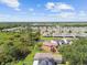 Aerial view showcasing homes with spacious backyards backing onto lush green spaces and a serene pond at 12716 Evington Point Dr, Riverview, FL 33579