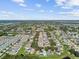 Expansive aerial view of a residential community showcasing well-maintained homes, lush greenery, and tranquil lakes at 12716 Evington Point Dr, Riverview, FL 33579