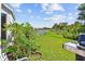 Lush backyard features a well-maintained lawn, beautiful landscaping, and a view of the neighborhood fence at 12716 Evington Point Dr, Riverview, FL 33579