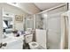 Bathroom with shower, large mirror, toilet, and white countertop and cabinets at 12716 Evington Point Dr, Riverview, FL 33579