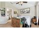 Bedroom with a ceiling fan, ensuite bathroom, and bright, airy natural lighting at 12716 Evington Point Dr, Riverview, FL 33579