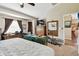 Bedroom with large windows, a wall-mounted TV, and an ensuite bathroom and adjacent dining room at 12716 Evington Point Dr, Riverview, FL 33579