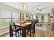 Open-concept dining area with wood floors and natural light at 12716 Evington Point Dr, Riverview, FL 33579