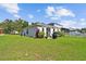 Charming home featuring a well-manicured lawn, fenced yard, and outdoor grill, perfect for outdoor living at 12716 Evington Point Dr, Riverview, FL 33579