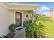 Front porch with a cozy seating area and lush greenery creating a welcoming entrance at 12716 Evington Point Dr, Riverview, FL 33579