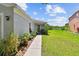 Inviting front entrance featuring a blue door, lush plants, and a sidewalk at 12716 Evington Point Dr, Riverview, FL 33579
