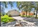 Well-kept home with a two-car garage and a green lawn at 12716 Evington Point Dr, Riverview, FL 33579