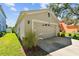 Exterior view of two car garage with neutral paint and a well-maintained lawn at 12716 Evington Point Dr, Riverview, FL 33579