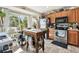 Well-lit kitchen with stainless steel appliances, a butcher block island, and a large window at 12716 Evington Point Dr, Riverview, FL 33579