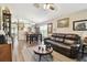 Comfortable living room with hardwood floors, ceiling fan, and an adjacent dining area at 12716 Evington Point Dr, Riverview, FL 33579