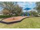 Community playground showcasing play structures with slides and climbing features for enjoyment at 12716 Evington Point Dr, Riverview, FL 33579