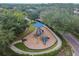 Aerial view of a well-maintained playground with slides, climbing features, and a blue shade covering at 12716 Evington Point Dr, Riverview, FL 33579