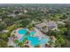 Aerial view of a community pool with a tanning deck, a covered eating area, and solar panels on the clubhouse roof at 12716 Evington Point Dr, Riverview, FL 33579