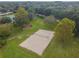 Aerial shot of a sand volleyball court in a neighborhood park with mature trees in the background at 12716 Evington Point Dr, Riverview, FL 33579