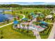 Aerial view of park with splash pad, playgrounds, and green space, perfect for Gathering fun at 14116 Trouville Dr, Tampa, FL 33624