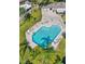 Breathtaking aerial view of community pool featuring lounge chairs and verdant landscaping at 14116 Trouville Dr, Tampa, FL 33624