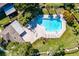 Stunning aerial view of community pool with ample seating and lush landscaping near a clubhouse at 14116 Trouville Dr, Tampa, FL 33624