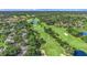 Aerial view of a verdant golf course winding through a residential community showcasing lush landscaping and scenic water features at 14116 Trouville Dr, Tampa, FL 33624