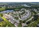 Aerial view of the neighborhood featuring mature landscaping and a community pond at 14116 Trouville Dr, Tampa, FL 33624