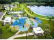 Aerial view of park featuring a playground, picnic areas, and a serene lake at 14116 Trouville Dr, Tampa, FL 33624