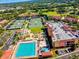 Aerial view of community featuring pool, tennis courts, and manicured landscaping at 14116 Trouville Dr, Tampa, FL 33624