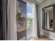 Balcony with glass sliding doors, curtains, and view of nature at 14116 Trouville Dr, Tampa, FL 33624