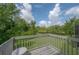 Balcony view showing nature, trees, a pond, and beautiful blue skies with clouds at 14116 Trouville Dr, Tampa, FL 33624