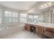 Bright bathroom with a large soaking tub, dual vanities, and ample natural light at 14116 Trouville Dr, Tampa, FL 33624