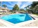 Relax in this pristine community pool surrounded by lounge chairs and lush greenery at 14116 Trouville Dr, Tampa, FL 33624