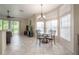 Bright dining area with a glass table, large windows, and a view of the backyard at 14116 Trouville Dr, Tampa, FL 33624