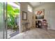 Bright entryway with tiled floors, artwork, and a view of the garden from the sliding door at 14116 Trouville Dr, Tampa, FL 33624