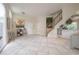 Bright and airy foyer featuring tile flooring, a staircase, and a mirrored bar area at 14116 Trouville Dr, Tampa, FL 33624